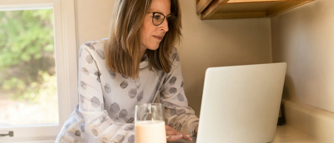 woman using her MacBook Pro inside white room